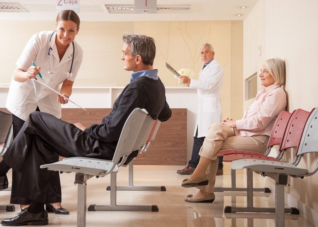 Patients In The Waiting Room At A Doctors Office.