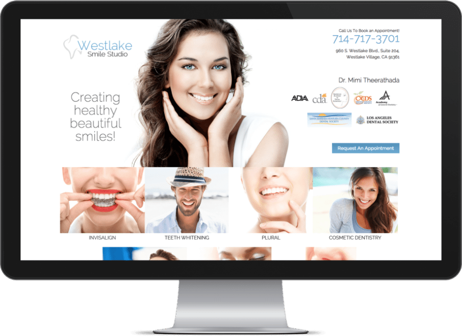 Screenshot Of A Prosthodontist Websites On A Monitor With A Smiling Girl