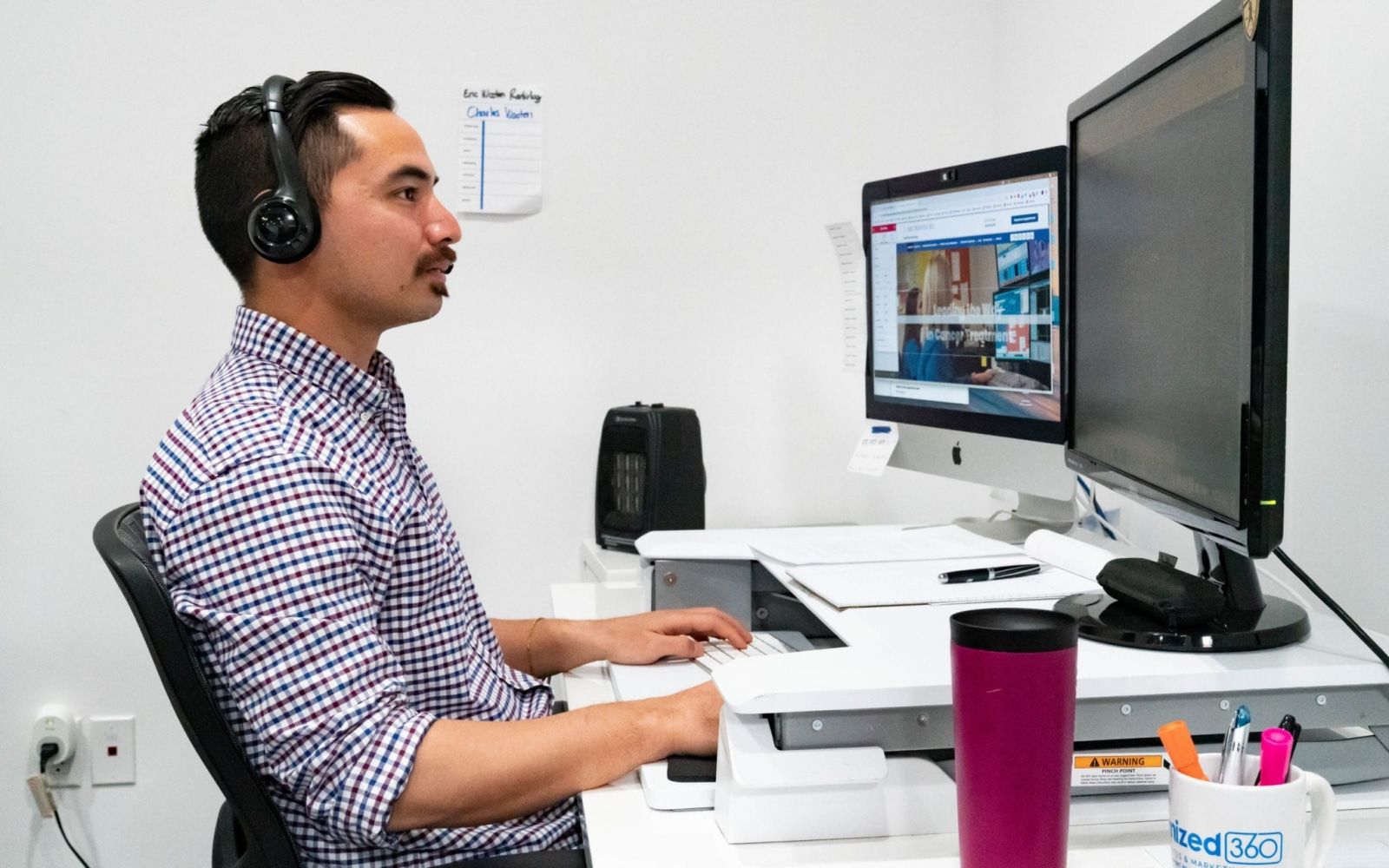 Account Manager Charles B. Sitting Behind His Desk Working On A Design For A Website O360® Team Pictures