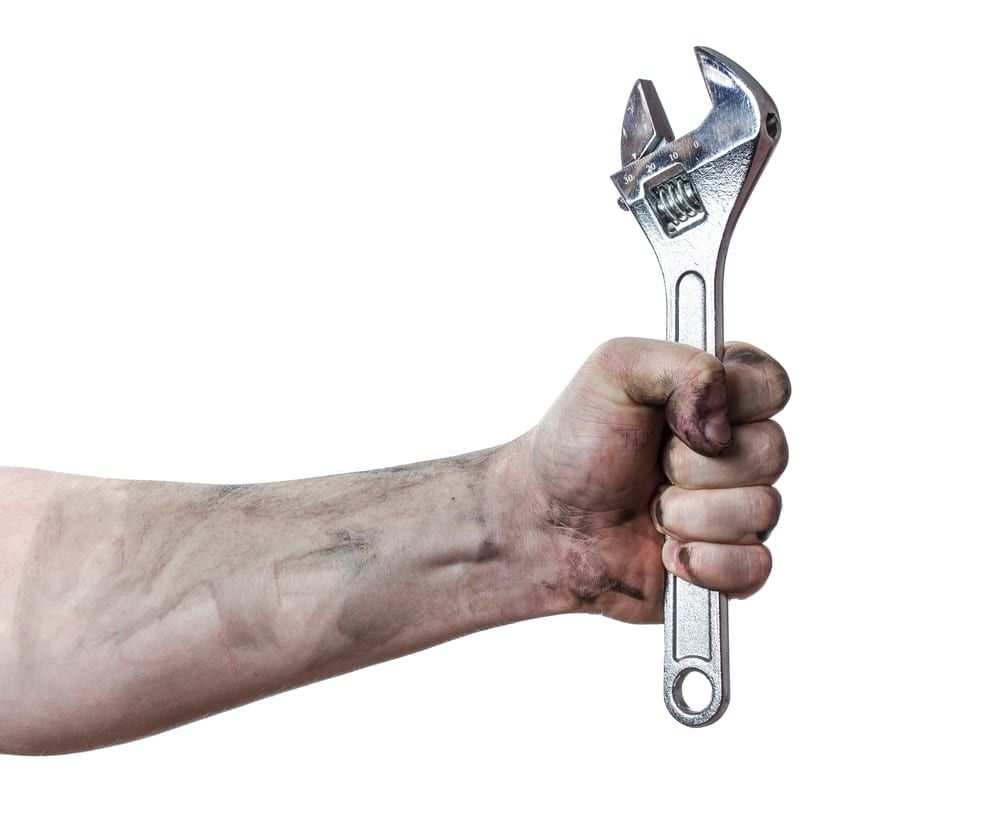 Hand Holding A Wrench To Reference Fixing