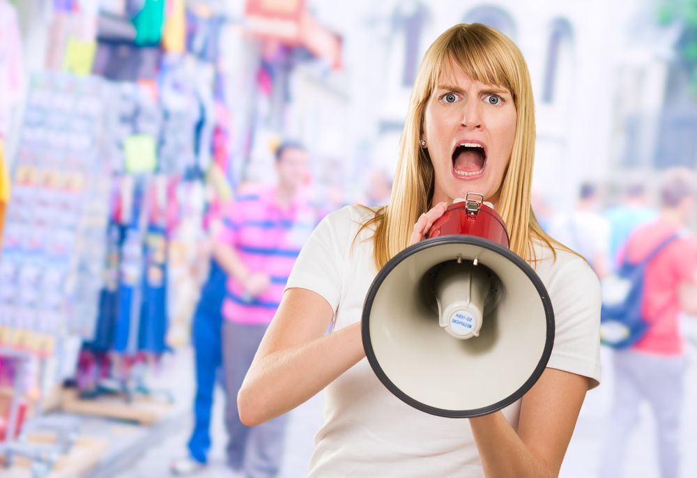Woman Screaming Through Megaphone At A Market