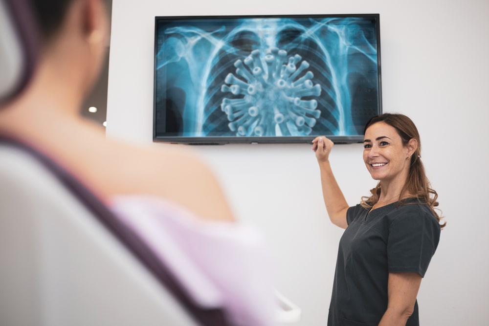 Nurse Pointing To Television