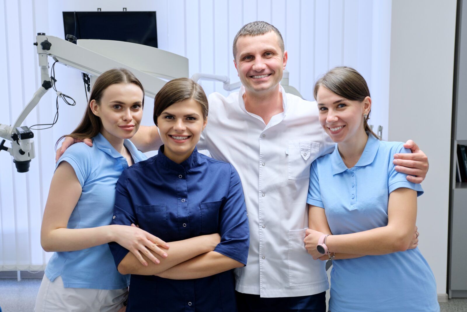 Portrait Of Male Doctor Dentist And Female Interns In The Dental Office