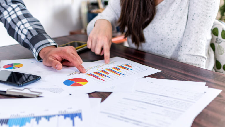 Selective focus shot of two businesspeople analyzing graphs at the office